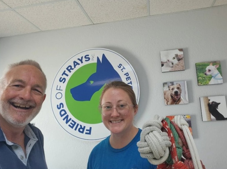 Skip and Jessica Salmond of Friends of Strays holding a bundle of rope dog toys